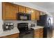 This kitchen has wooden cabinets, black appliances, and ample counter space at 1459 S Mara Dr, Apache Junction, AZ 85120