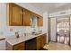 The kitchen features wooden cabinets, a sink, and an attached dining area at 1459 S Mara Dr, Apache Junction, AZ 85120