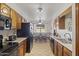Functional kitchen featuring wood cabinets, black appliances, and tile flooring at 1459 S Mara Dr, Apache Junction, AZ 85120