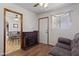 Cozy room featuring a fireplace, wood floors, and a door leading to the dining room at 1459 S Mara Dr, Apache Junction, AZ 85120