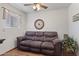 Comfortable sitting room featuring a sofa, decorative clock, and natural light at 1459 S Mara Dr, Apache Junction, AZ 85120