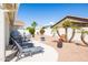 Well maintained backyard featuring an outdoor seating, BBQ grill, and well-maintained landscaping at 15516 W Verde Ln, Goodyear, AZ 85395
