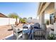 Relaxing backyard patio area with stylish outdoor furniture, landscaped yard, and ample space for entertaining at 15516 W Verde Ln, Goodyear, AZ 85395