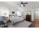 Light and airy bedroom with high ceilings, dark wood flooring, and a ceiling fan at 15516 W Verde Ln, Goodyear, AZ 85395