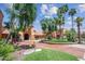 Impressive clubhouse entrance with manicured landscaping, palm trees, and a circular driveway at 15516 W Verde Ln, Goodyear, AZ 85395