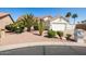 Charming single-story home featuring desert landscaping, mature trees, and a well-maintained two-car garage at 15516 W Verde Ln, Goodyear, AZ 85395