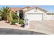 Beautiful single-story home with desert landscaping, including mature trees, and an attached two-car garage at 15516 W Verde Ln, Goodyear, AZ 85395
