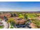Scenic aerial view of a golf course and the surrounding community with lush greenery at 15516 W Verde Ln, Goodyear, AZ 85395