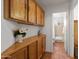 Hallway with upper and lower cabinets that leads to the bathroom at 15516 W Verde Ln, Goodyear, AZ 85395
