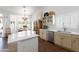 Modern kitchen with a center island, stainless steel appliances, and views to the dining area at 15516 W Verde Ln, Goodyear, AZ 85395