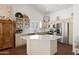 Bright kitchen with stainless steel appliances, quartz countertops, and a center island at 15516 W Verde Ln, Goodyear, AZ 85395