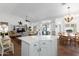 Bright open-concept kitchen with island, dining area, and seamless flow to the cozy living room at 15516 W Verde Ln, Goodyear, AZ 85395
