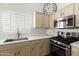 Updated kitchen features modern appliances, ample counter space and stainless steel oven at 15516 W Verde Ln, Goodyear, AZ 85395