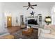 Cozy and bright living room featuring wood floors, vaulted ceilings, and a neutral color palette at 15516 W Verde Ln, Goodyear, AZ 85395