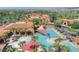 Aerial view of community pool with palm trees, shade coverings and swimming residents at 15516 W Verde Ln, Goodyear, AZ 85395