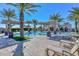 Community pool and lounge area with palm trees and shade structures at 15516 W Verde Ln, Goodyear, AZ 85395