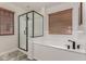 Modern bathroom featuring a black framed glass shower, soaking tub, and wood toned blinds at 15604 N 173Rd Ln, Surprise, AZ 85388