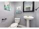 Powder bathroom with a white pedestal sink, framed mirror, and coordinated wall art at 15604 N 173Rd Ln, Surprise, AZ 85388