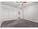 Bedroom with a closet, ceiling fan, carpet flooring, and natural light at 15604 N 173Rd Ln, Surprise, AZ 85388