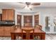 Inviting dining area with an large wooden table and view into the backyard at 15604 N 173Rd Ln, Surprise, AZ 85388
