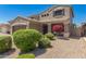 Charming two-story home featuring desert landscaping, a two-car garage, and a cozy front porch at 15604 N 173Rd Ln, Surprise, AZ 85388