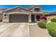 Charming two-story home featuring a two-car garage, desert landscaping, and a welcoming front porch at 15604 N 173Rd Ln, Surprise, AZ 85388