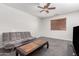 Living room featuring a grey sofa, carpet flooring, and a wood toned coffee table at 15604 N 173Rd Ln, Surprise, AZ 85388