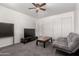 Cozy living room featuring a TV, futon sofa, and natural light at 15604 N 173Rd Ln, Surprise, AZ 85388