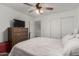 Spacious main bedroom with a fan, carpet flooring, dresser, and closet at 15604 N 173Rd Ln, Surprise, AZ 85388