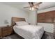 Cozy main bedroom featuring a ceiling fan, carpet flooring, and wood furniture at 15604 N 173Rd Ln, Surprise, AZ 85388