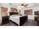 Main bedroom with a ceiling fan, carpeted floors, blinds and a dark wood sleigh bed at 15604 N 173Rd Ln, Surprise, AZ 85388