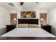 Main bedroom with a ceiling fan, blinds, a wooden headboard, and bedside lamps at 15604 N 173Rd Ln, Surprise, AZ 85388