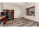Spacious office featuring a wood desk, black chair, and wood flooring at 15604 N 173Rd Ln, Surprise, AZ 85388