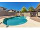 Sparkling pool in private backyard oasis featuring tropical landscaping, rock accents, and a lounging area at 15604 N 173Rd Ln, Surprise, AZ 85388