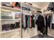 Bright walk-in closet with shelving, clothing racks, and carpeted flooring at 15604 N 173Rd Ln, Surprise, AZ 85388