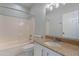 A bathroom with white cabinets, granite countertop, tile floors, and shower-tub combo at 15903 N 138Th Ave, Surprise, AZ 85374