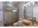 Bathroom featuring stone tile, glass enclosed shower, and a vessel sink at 15903 N 138Th Ave, Surprise, AZ 85374