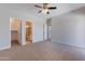 Bright bedroom featuring a walk-in closet and an en-suite bathroom with tiled shower at 15903 N 138Th Ave, Surprise, AZ 85374
