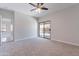 Bedroom features a ceiling fan, neutral walls, and glass door access to outdoor pool at 15903 N 138Th Ave, Surprise, AZ 85374