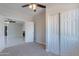 This carpeted bedroom features a ceiling fan, closet, and neutral walls at 15903 N 138Th Ave, Surprise, AZ 85374