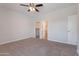 Carpeted bedroom with ceiling fan and doors to walk-in closet and en-suite bathroom at 15903 N 138Th Ave, Surprise, AZ 85374