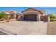 Spacious home exterior featuring a large driveway and two-car garage with low maintenance desert landscaping at 15903 N 138Th Ave, Surprise, AZ 85374