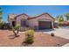 Home exterior with well-maintained desert landscaping and low maintenance front yard at 15903 N 138Th Ave, Surprise, AZ 85374