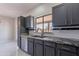 Bright kitchen showcasing granite countertops, stainless steel appliances, and a view to the backyard at 15903 N 138Th Ave, Surprise, AZ 85374