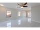 Bright living room with tile flooring, neutral walls, ceiling fan, and natural light at 15903 N 138Th Ave, Surprise, AZ 85374