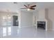 Open concept living room with pool view, tile flooring, fireplace, and ceiling fan at 15903 N 138Th Ave, Surprise, AZ 85374