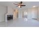 Spacious living room featuring a fireplace, tile floors, and neutral paint colors at 15903 N 138Th Ave, Surprise, AZ 85374