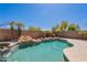Relaxing backyard pool and hot tub surrounded by mature landscaping, offering ultimate privacy and tranquility at 15903 N 138Th Ave, Surprise, AZ 85374