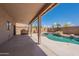 Inviting covered patio and pool area with built-in barbecue, perfect for outdoor entertaining at 15903 N 138Th Ave, Surprise, AZ 85374