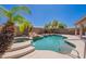 Relaxing pool and spa with waterfall feature, complemented by a lush, tropical backyard oasis at 15903 N 138Th Ave, Surprise, AZ 85374
